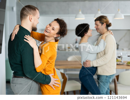 Men and women dancing during house party. 121143694