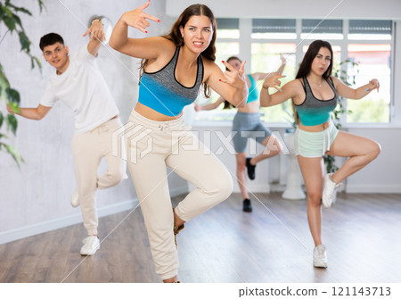 Group of teenagers dancing modern dance in ballroom 121143713