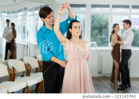 During rehearsal, guy and girl participants of dance workshop perform social pair dance 121143743