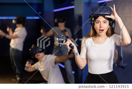 girl is exhilarated by turn of events in VR game and moved virtual reality glasses to forehead 121143915