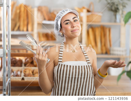 Young saleswoman holding a service clip ready to serve customers Young saleswoman holding a service clip ready to serve customers 121143936