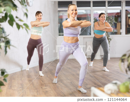 Positive women engaged in active dancing Positive women engaged in active dancing 121144064