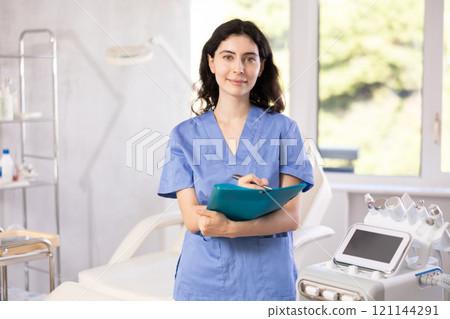 doctor meticulously stands in her clinic 121144291