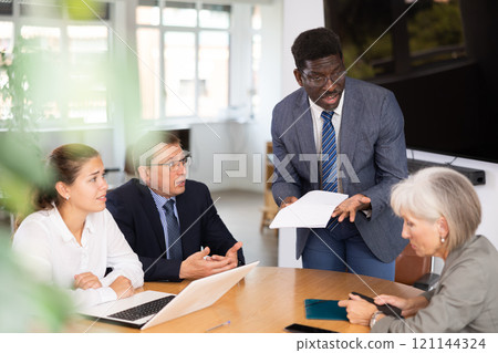 African man auditor speaks about trouble before meeting of frowning shareholders of businessmen 121144324