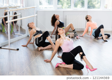 Group of women in high heels dances on floor 121144369