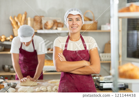 Young girl standing in bakehouse, ready to start baking 121144438