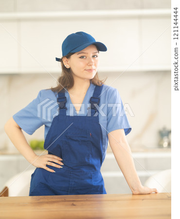 Young woman worker at table in kitchen 121144444