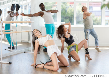 Female dancer performing contemporary sass dance floorwork in studio 121144460