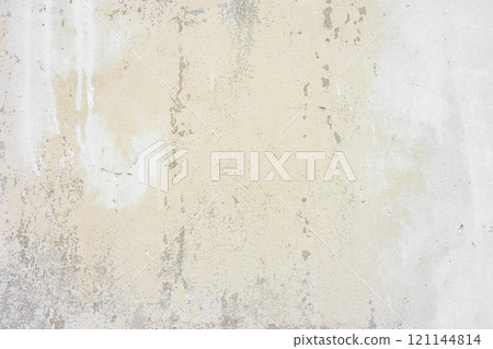 Textured beige plaster wall surface with peeling paint. Aged, weathered concrete background Textured beige plaster wall surface with peeling paint. Aged, weathered concrete background 121144814