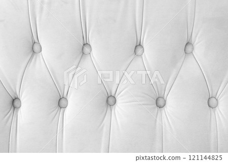 Capitone, Chesterfield style suede fabric texture, white diamond buttoned white background Capitone, Chesterfield style suede fabric texture, white diamond buttoned white background 121144825