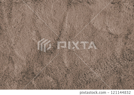 Soft fluffy brown carpet texture, synthetic textile fur, plush background 121144832