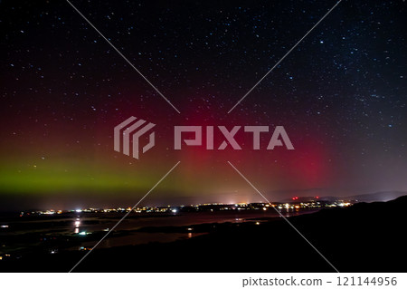 The Aurora Borealis, the northern lights, showing up above Maghery, Burtonport, Arranmore and Dungloe in County Donegal, Ireland. 121144956