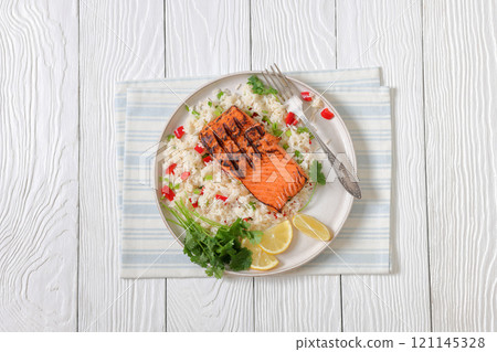 grilled red salmon fillet with rice, top view 121145328