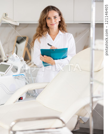 Young female doctor taking notes in medical room Young female doctor taking notes in medical room 121146405