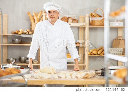 Young guy standing in bakehouse, ready to start baking Young guy standing in bakehouse, ready to start baking 121146462
