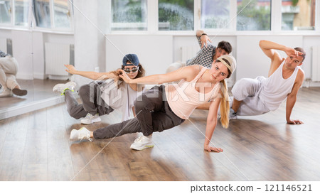 Young girl practicing breakdance floor-works in training hall 121146521