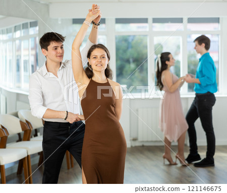 During rehearsal, guy and girl participants of dance workshop perform social pair dance 121146675