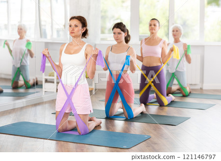Adult woman exercising with pilates band Adult woman exercising with pilates band 121146797