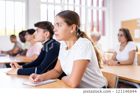 Girl attending lecture in college 121146844