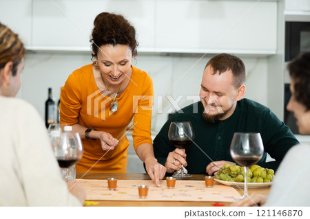 Group of friends is playing board game. 121146870