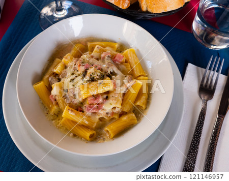Popular dish pasta Rigatoni a la carbonara Popular dish pasta Rigatoni a la carbonara 121146957
