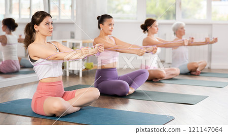 Young woman exercising with pilates loop Young woman exercising with pilates loop 121147064