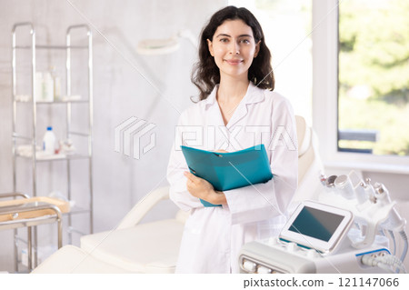 doctor meticulously stands in her clinic 121147066