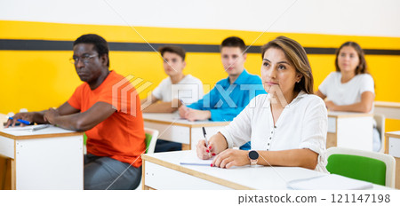 Woman attending lecture in taxi training school 121147198