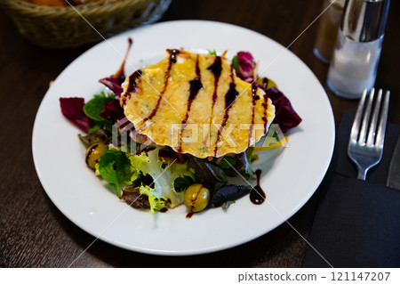 Close up of scallop snack baked with cheese served on seashell 121147207