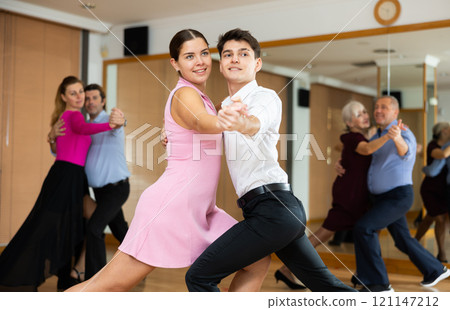 Young couple dancing slow ballroom dance in choreography studio 121147212