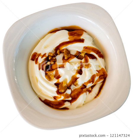 Airy yogurt foam with nuts and caramel - sweet delicious dessert closeup 121147324