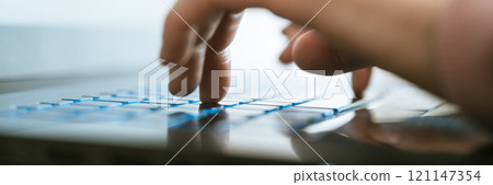 Female hands typing on laptop computer keyboard 121147354