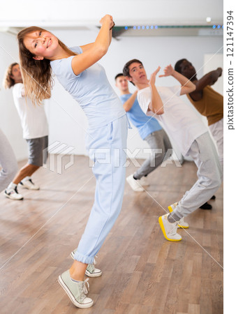 Group of different people rehearsing dance in dance studio Group of different people rehearsing dance in dance studio 121147394