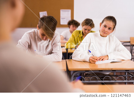 Group of school kids and teacher during lesson Group of school kids and teacher during lesson 121147463