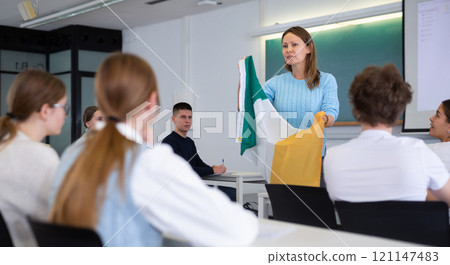 Female professor shows students flag of Ireland Female professor shows students flag of Ireland 121147483
