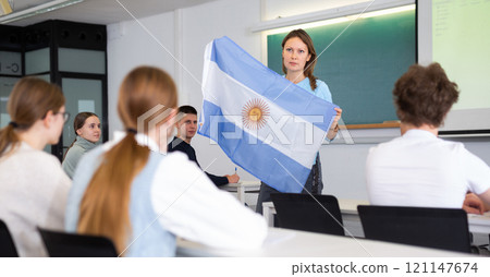 Female professor shows students flag of Argentina Female professor shows students flag of Argentina 121147674