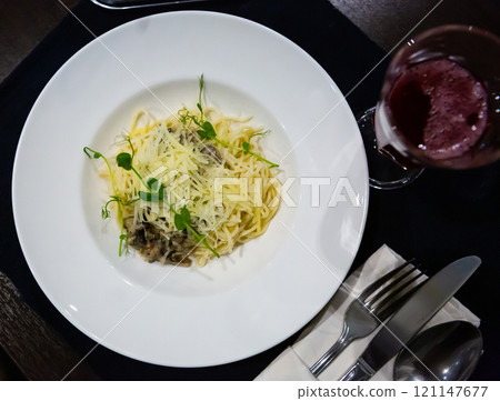 Italian creamy mushroom pasta with cheese garnished with microgreens Italian creamy mushroom pasta with cheese garnished with microgreens 121147677
