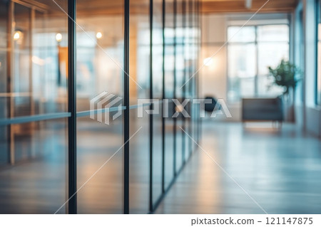 Defocused Meeting Room Background with Glass Walls and Modern Decor in an Office Space 121147875