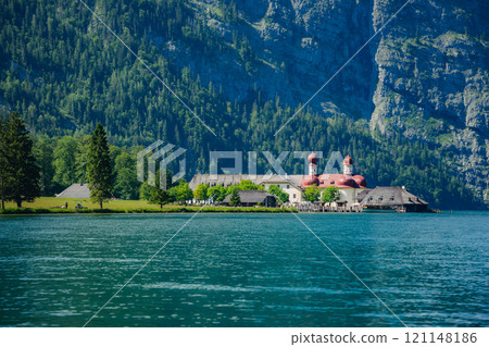 Konigssee Lake in Bavaria Germany with Church by the Lake White Boat Forested Mountain and Beautiful Sunny Trekking in Berchtesgaden German Alps. High quality photo Konigssee Lake in Bavaria Germany with Church by the Lake White Boat Forested Mountain and Beautiful Sunny Trekking in Berchtesgaden German Alps. High quality photo 121148186