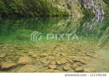 Konigssee Lake in Bavaria Germany with Church by the Lake White Boat Forested Mountain and Beautiful Sunny Trekking in Berchtesgaden German Alps. High quality photo Konigssee Lake in Bavaria Germany with Church by the Lake White Boat Forested Mountain and Beautiful Sunny Trekking in Berchtesgaden German Alps. High quality photo 121148188