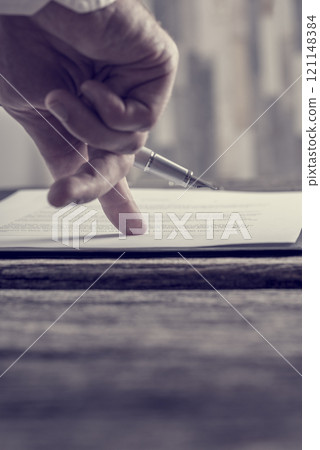 Businessman hand pointing with his finger where to sign a contract or document 121148384