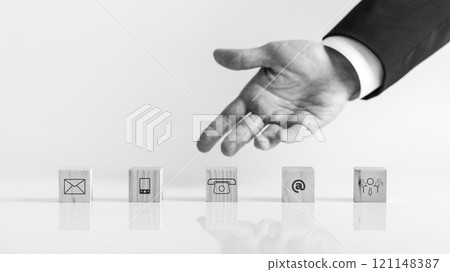 Businessman hand showing wooden blocks with contact symbols Businessman hand showing wooden blocks with contact symbols 121148387