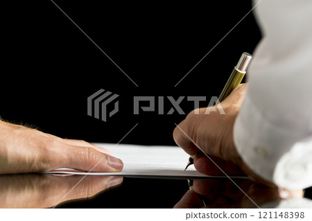 Businessman or attorney signing a document, contract or legal paper Businessman or attorney signing a document, contract or legal paper 121148398