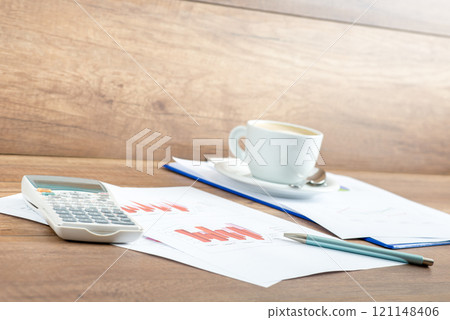 Coffee and paperwork on an office desk Coffee and paperwork on an office desk 121148406
