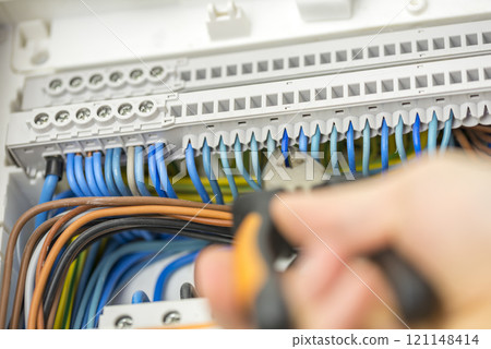 Electrician repairing faulty wiring Electrician repairing faulty wiring 121148414