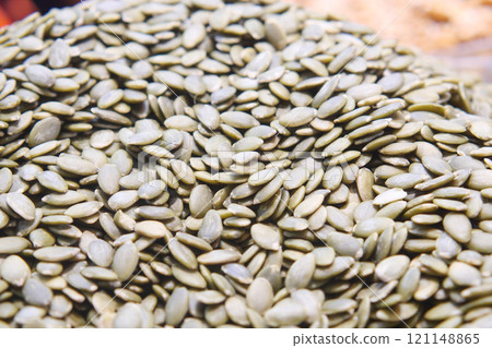 A CloseUp Image of Raw Green Pumpkin Seeds Beautifully Arranged on Display for Viewing 121148865