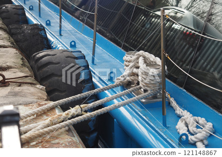 Ropes and Tires are Spread Across the Blue Boat Deck, Surrounded by Stunning Reflections 121148867