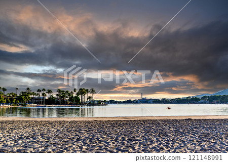 Sunset views of Alcudia Beach, next to the port. Balearic Islands, Spain 121148991