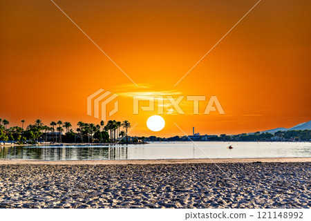 Sunset views of Alcudia Beach, next to the port. Balearic Islands, Spain Sunset views of Alcudia Beach, next to the port. Balearic Islands, Spain 121148992