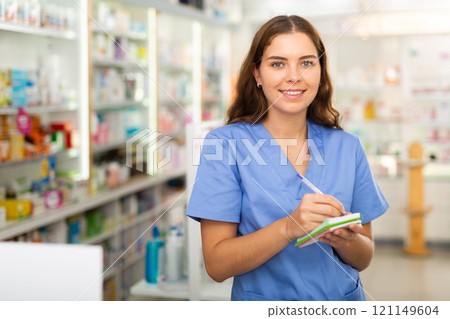 Pharmacist in drugstore with notebook 121149604
